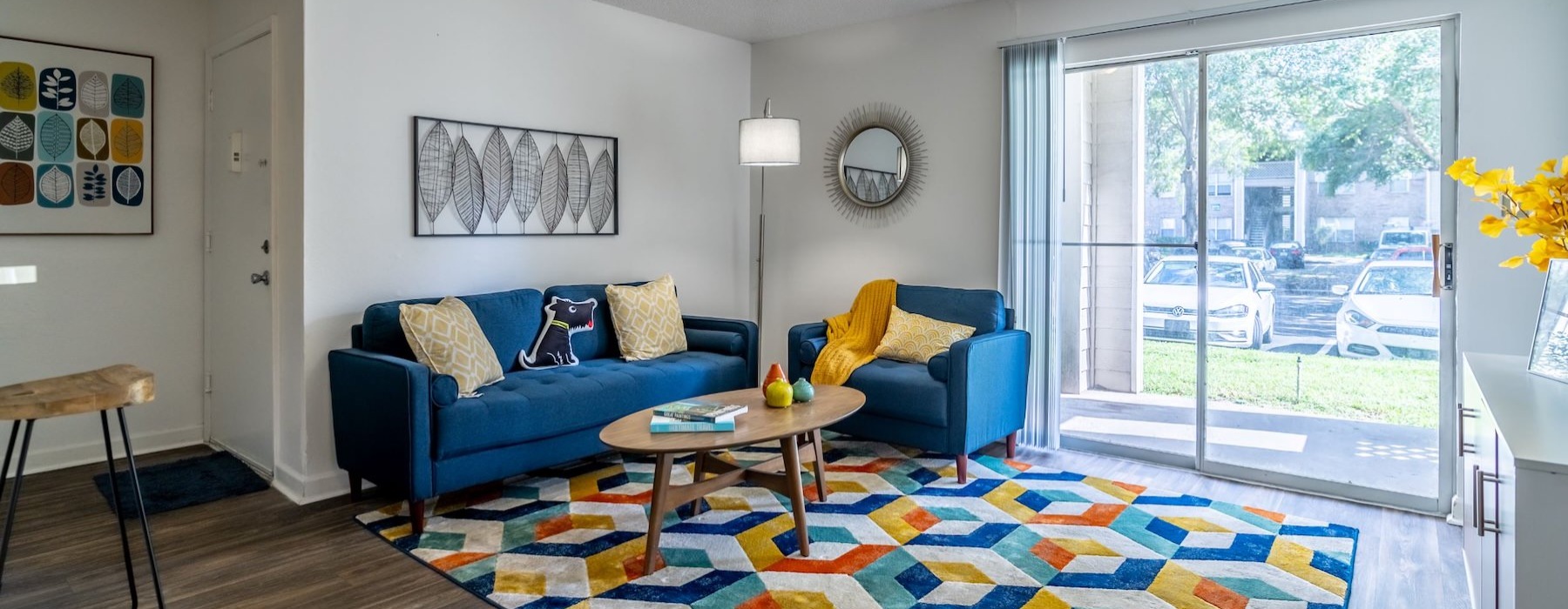 a living room with a blue couch and a coffee table