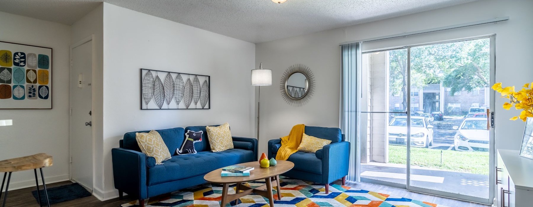 a living room with a blue couch and a coffee table