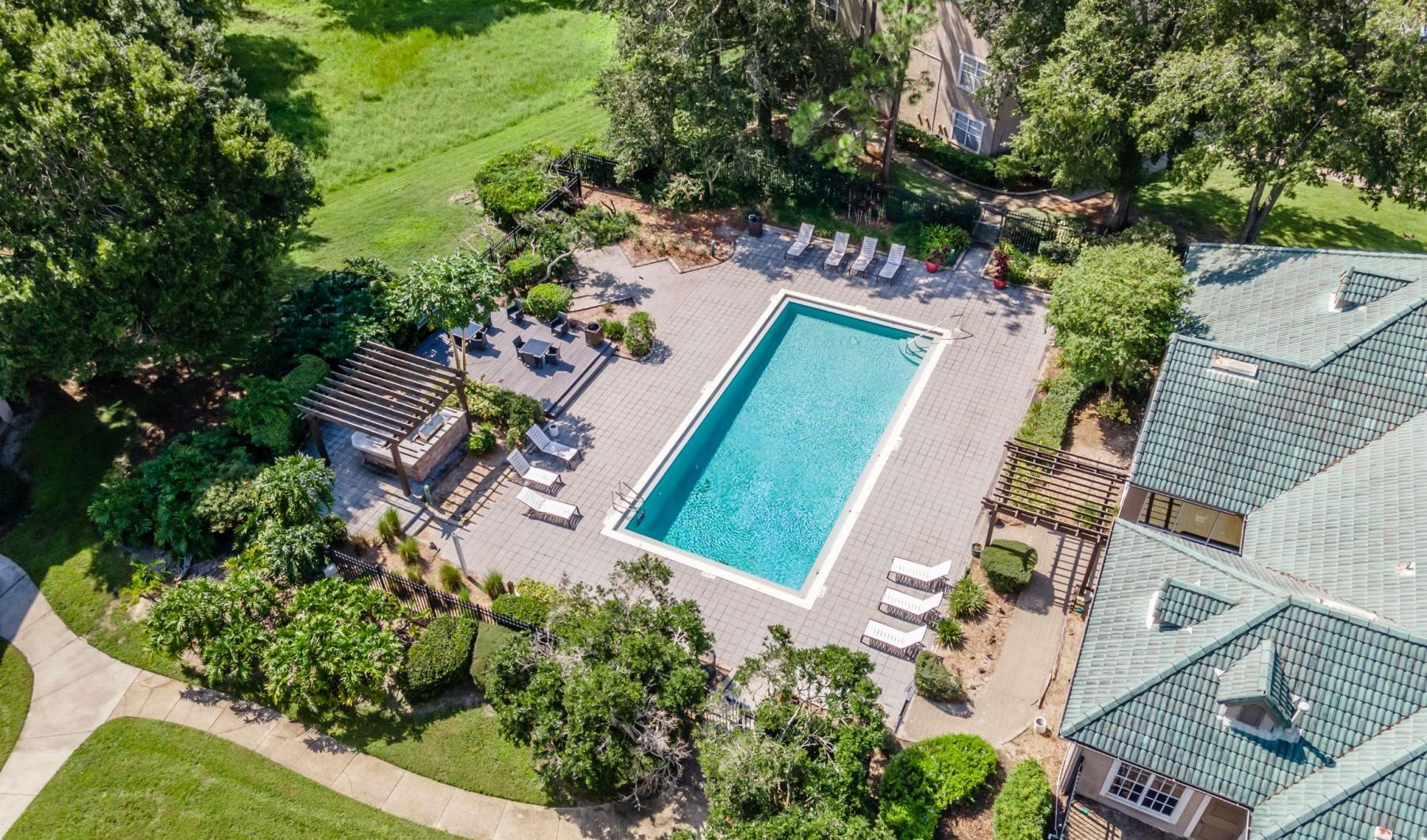 an aerial view of a pool in a courtyard