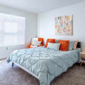 a bedroom with a bed and a lamp
